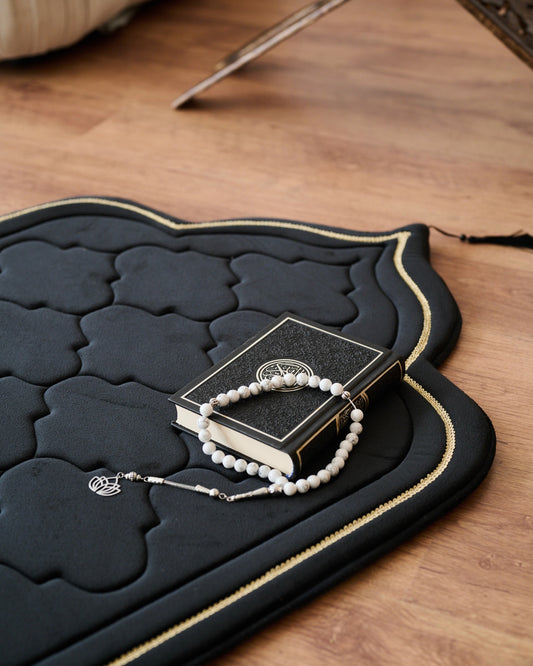 luxury thick padded foam prayer mat with a rosary, candles and Quran