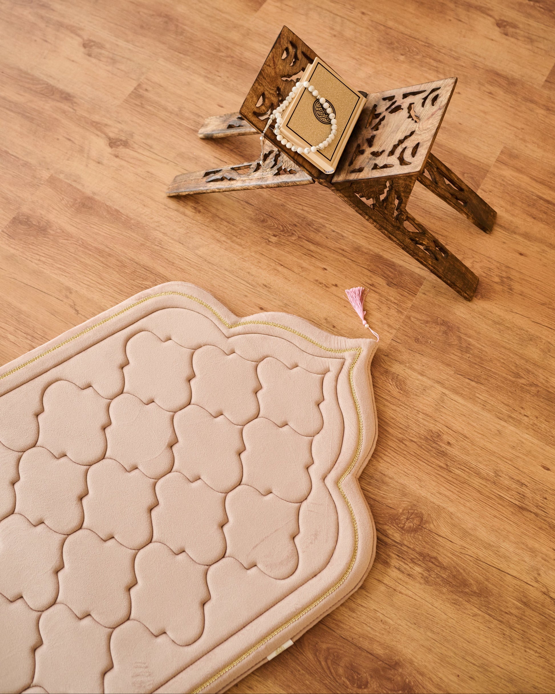Wooden prayer mat and prayer rug on a wooden floor